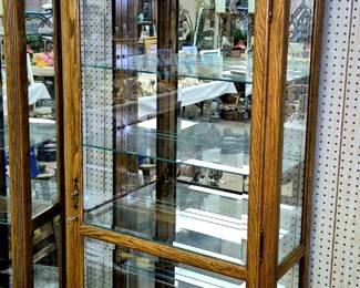 Traditional oak lighted curio cabinets.