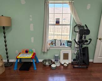 Dog bowls, stationary bike and books