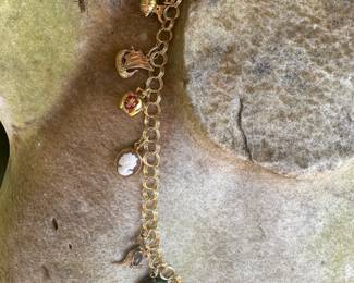 #6- 10kt gold charm bracelet with 10 charms 6" - weight - 
