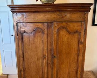 Antique French armoire and a bronze female breastplate on stand