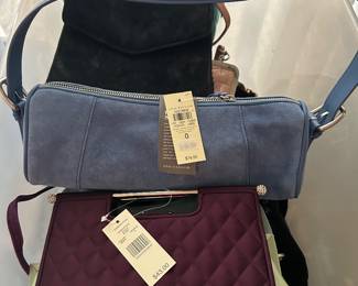 Totes filled with purses. Many are new with tags. 