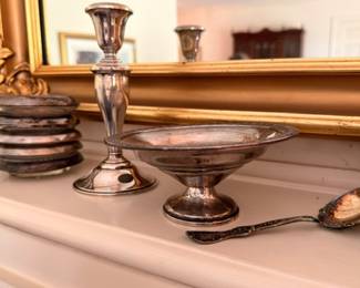 Sterling silver candlestick compote and coasters on mantel
