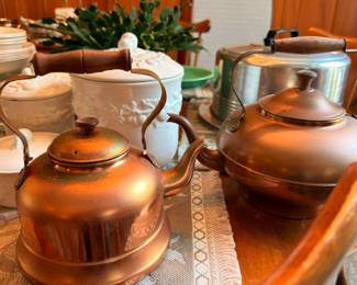 Vintage copper and aluminum teakettles with ceramic crocks