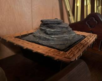 Stacked slate decorative stones on wicker tray
