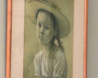 Graphite portrait drawing of young girl in straw hat framed