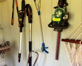 Yard tools lot pole pruner hedge trimmer hose reel and hammock