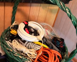Green basket of extension cords and cables