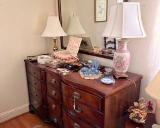 Mahogany bowfront dresser with mirror lamps and vanity items