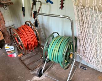Garden hose reel with green hose and Tru Seal can