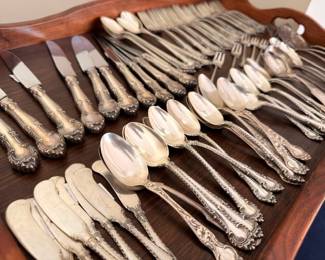 Ornate silverplate flatware set with knives spoons and forks