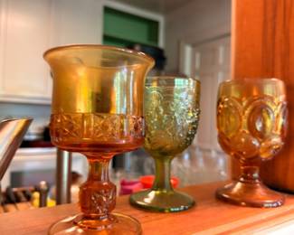 Amber and green carnival glass goblets with moon and star pattern
