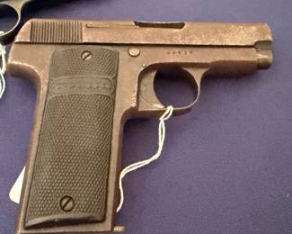 Vintage semi-automatic pocket pistol with checkered grips