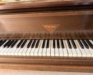 Fischer piano brand plate and ivory keys closeup