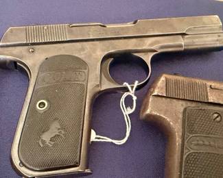 Two vintage Colt semi-automatic pistols with rampant colt grips