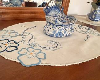 Blue and white floral porcelain covered tureen on embroidered doily