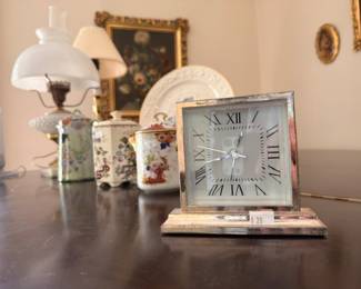 Silver framed mantel clock with chinoiserie tea caddies and milk glass lamp