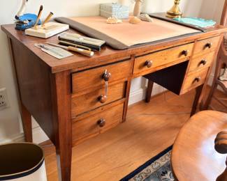 Antique oak writing desk with seven drawers and leather-top slant front