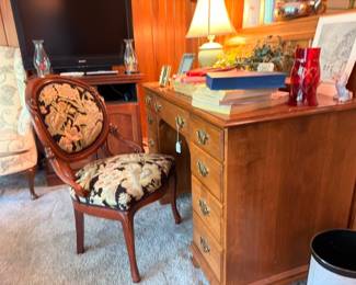 Den scene with Victorian balloon back chair maple kneehole desk and lamps