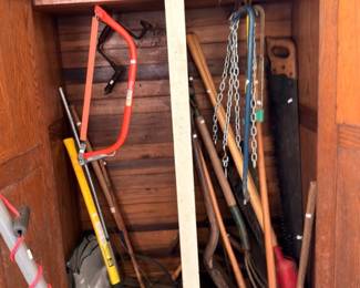 Yard tools lot shovels rakes axe and garden hose