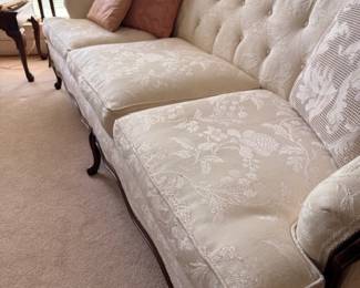Ivory damask tufted Queen Anne sofa with mauve pillows