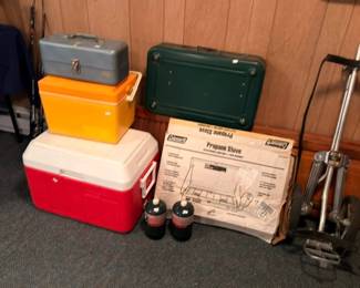 Coleman propane stove with red cooler propane cylinders and exercise equipment