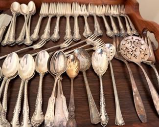 Assorted vintage silverplate serving spoons and forks