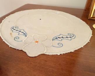 Round embroidered linen doily with dogwood flower motif