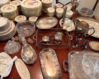 Dining table with silverplate serving trays china dinnerware and crystal