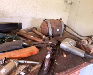 Vintage hand tools lot planes hammers and saws on workbench