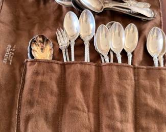 Silver flatware set in roll-up storage pouch