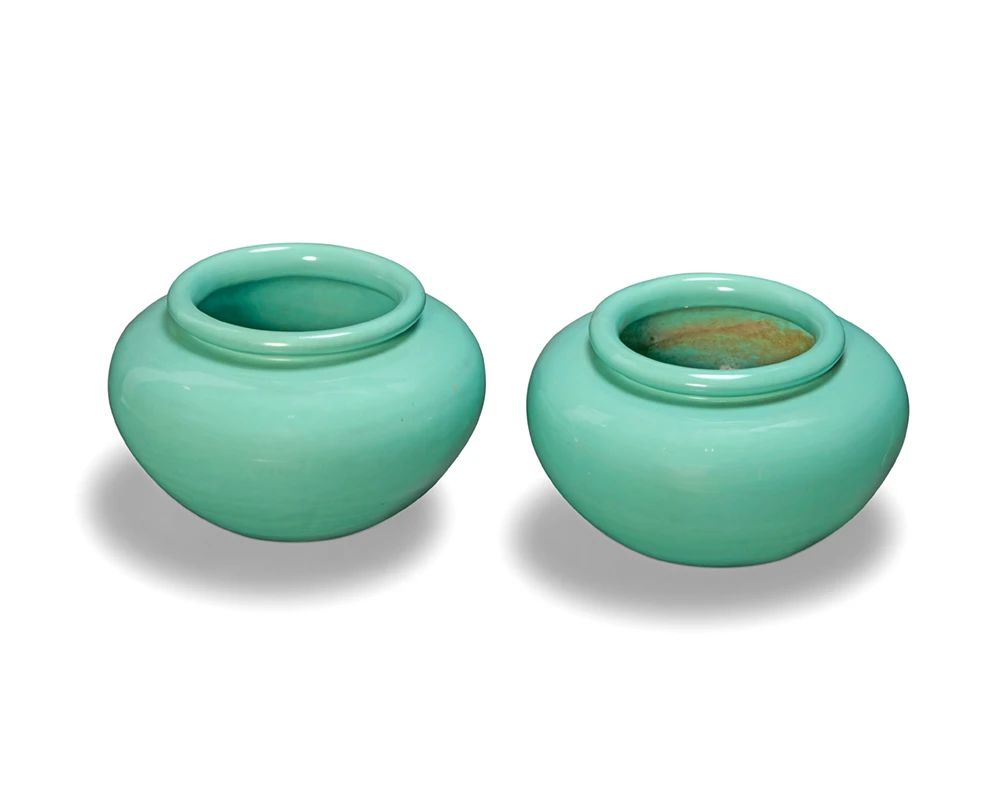 1001 A pair of Pacific turquoise glazed pottery planters Second quarter 20th century Each marked in the molding: PACIFIC / MADE IN USA 2 pieces Each: 10.625" H x 17" Dia. Estimate: $500 - $700