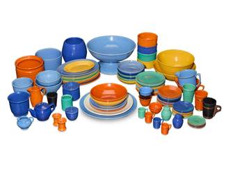 1273 A collection of Bauer glazed pottery ringware table items Circa 1930s Each unmarked Comprising various plates, bowls, cups, and other service items, including but not limited to: a large footed fruit bowl, a set of oval plates, a set of luncheon plates, a set of small dishes, pitchers, bowls, cups, candlesticks, stackable leftovers bowls, salt and pepper shakers, and a teapot 91 pieces approximately Fruit bowl: 7.375" H x 14.375" Dia.; Largest plate: 14.375" Dia.; Widest bowl: 12.25" Dia. Estimate: $600 - $800