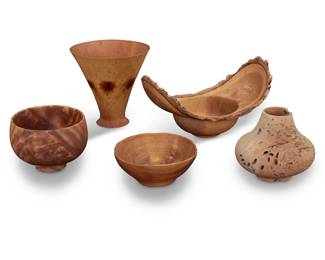1388 A group of wood turned vessels Late 20th century Live edge burn marked: John Berglund / 97; conical incised: T. Van Cleave / Norfolk / Pine; one incised: Howard Lewis / Persimmon / 11/90; larger bowl incised: Straka / Roberta / Wood; smallest incised: Paul Gerhart / Koa Wood 5 pieces Tallest: 7.75" H x 8" Dia.; Berglund: 7" H x 12.75" W x 8" D; Smallest: 2.75" H x 6.5" W x 5.75" D Estimate: $300 - $500