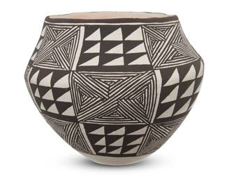 1153 Lucy Lewis (1890-1992, Acoma Pueblo) A black and white pottery olla, late 20th century Signed to underside: Lucy M. Lewis With black on white slip checkered pattern fine-line geometric panels, alternating with panels of serrations 4.5" H x 5.375" Dia. Estimate: $500 - $700