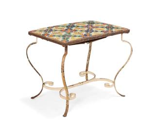1266 A Spanish Revival tile top table Early 20th century With foliate pattern polychrome ceramic tiles set in a metal frame, raised on an enameled metal scrollwork base 22" H x 26.5" W x 18.5" D Estimate: $400 - $600