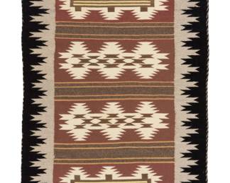 1235 A Navajo Wide Ruins textile Late 20th century, Diné Woven in grey, black, brown, yellow, and cream wool featuring four rows of conjoined serrated diamonds alternating with striped banding, with a complex serrated border to two sides 44.5" H x 32.5"W Estimate: $300 - $500
