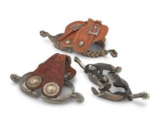 1111 Three pairs of spurs Late 20th century Three works:  A pair of Madole wrought iron spurs Each stamped: Madole / Tully Hole Saddlery Tres Pinos CA Each with sterling silver overlay to outer heel band, shanks, and outer strap button, with pierced metal rowels and Tully Hole Saddlery tooled leather straps with silver metal buckles Each: inner heel band: 3.25" W; heel depth: 3.25" D; shank: 2" L; rowels: 1.25" Dia.  A pair of Fleming steel spurs Each stamped: Fleming / Mexico Each with chased sterling silver overlay to outer elements, with curved shanks, ten-point rowels and rubber straps Each: inner heel band: 3.125" W; heel depth: 3.375" D; shank: 2.25" L; rowels: 1" Dia.  A pair of unmarked spurs with chased designs to heel bands, and openwork rowels, with tooled leather straps with sterling silver conchos and buckles Each: inner heel band: 3.125" W; heel depth: 2.875" D; shank:1" L; rowels: 1.25" Dia.  6 pieces total Estimate: $300 - $500