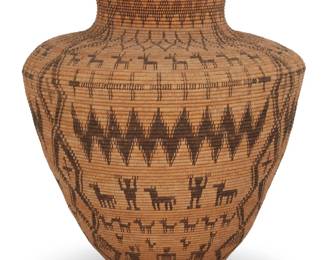 1049 A monumental Apache pictorial basketry olla Late 19th century; Southwest United States A large coiled olla form storage basket depicting figures with raised hands, horses, dogs, deer with antlers and other small animals and stacked diamond columns and bands of crosses and zigzag motifs, likely worked in 'Devil's Claw' and willow 24.5" H x 21" Dia. Estimate: $2,000 - $4,000