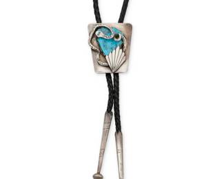 1340 A Zuni silver and turquoise bolo tie, attributed to Dan Simplico Attributed to Dan Simplicio (1917-1970, Zuni) Stamped: Sterling A sterling silver bolo tie featuring a trapezoidal slide with a large set slab turquoise, with an elaborate silver snake and stylized leaf overlay, attached to a black braided leather cord with silver cone and ball tips Bolo slide: 2.125" H x 1.75" W; cord: 39" L approximately 54.0 grams gross Estimate: $300 - $500