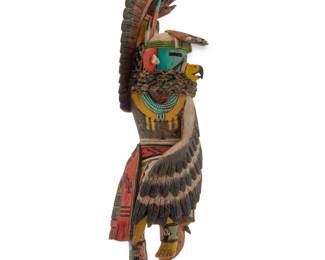 1203 Brendan Kayquoptewa (b. 1970, Hopi-Tewa) A painted carved cottonwood Eagle Dancer katsina, early 21st century Incised to base: [deer tracks] / B KAYQUOPTEWA Housed in a plastic display case with mirrored back Figure: 9.75" H x 2.625" W x 2.75" D; Case: 10.375" H x 4.375" W x 4" D Estimate: $200 - $400