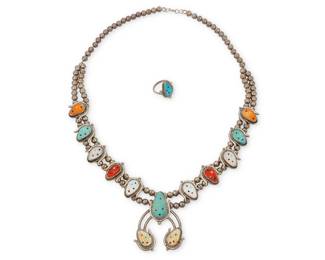 1327 A set of Beverly Etsate Zuni sterling silver and stone set jewelry Beverly Etsate (b. 20th century, Zuni) Late 20th/21st century Etched: Bev Etsate / Zuni Comprising a Zuni squash blossom necklace with ten carved multicolored stone inlay "corn" blossoms including alternating turquoise, coral, mother of pearl, shell, and spiny oyster, suspending a silver naja with applied turquoise and shell blossoms, as well as a matching blue carved turquoise ring 2 pieces Necklace: 24.75" L x 2.25" H; ring size: 8.25 91.1 grams gross Estimate: $600 - $800
