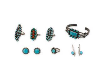1383 A group of Southwest silver and set stone jewelry Mid/late 20th century Two variously marked for maker and/or for sterling: J.M. Begay [Diné] / Seven works with set turquoise comprising a three-wire cuff bracelet with cluster-set turquoise and twisted wire and silver ball accents, together with three large Zuni style cluster set petit point turquoise rings, one with coral, as well as a single stone set ring and a pair of similar design earrings, and a pair of modernist-style turquoise drop earrings 9 pieces Cuff: 6.375" total inner C x 1"H; Ring sizes: 9.5 to 6.5; Earrings: 1.25" H to 0.75" Dia. 77.2 grams gross Estimate: $600 - $800