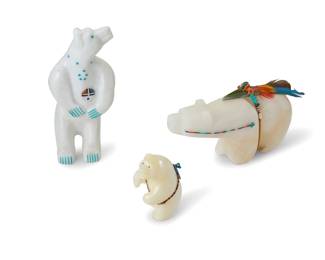 1356 Three Zuni carved stone fetish bears Mid/late 20th century, Zuni Pueblo Each variously incised with signature, initials, or artist's cipher Comprising one Andres Lementino carved from marble with turquoise accents and a shell and hardstone Tawa sunface, one carved white hardstone mounted with offerings and a feather with heartline, and another carved white hardstone mounted with offerings 3 pieces Lementino: 6" H x 2.75" W x 1.5" D; Smallest: 2.75" H x 1.5" W x 1.875" D Estimate: $200 - $400