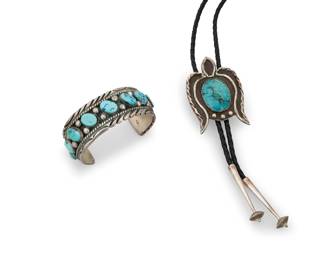 1338 Two Southwest sterling silver and turquoise jewelry items Mid/late 20th century Each unmarked Comprising a chunky cuff with large row set turquoise and silver wire and silver ball accents and stamped edges, as well as a sterling silver and turquoise bolo tie with naja-style plaque slide set to a braided black leather cord with silver end tips 2 pieces Cuff: 6.75" total inner C x 1" H, gap: 1.5"; Bolo slide: 2.75" H x 1.75" W; cord: 38" L approximately 122.0 grams gross Estimate: $400 - $600