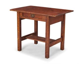 1076 A Gustav Stickley oak library table, no. 652 1905-1912 Underside applied with remnants of original wood bearing red joiner's Craftsman Workshops mark The single-drawer table with plank H-stretcher 29" H x 36.25" W x 24" D Estimate: $800 - $1,200