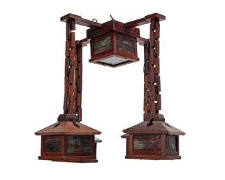 1225 An Arts & Crafts wood and slag glass chandelier Early 20th century Each lower fixture with 'Union' knob switch Possibly W. B. Brown (1906-1923), with five lights, each housed in a slag glass and wood shade, four issuing from a chain-link-form wood arms, electrified 26" H x 29" W x 29" D Estimate: $1,000 - $2,000
