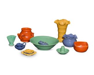 1271 A group of Matt Carlton glazed pottery items for Bauer Circa 1930s Five drip trays impressed: BAUER / LOS ANGELES; and variously numbered 8 or 10 Comprising: 3 strawberry pots 3 fan vases 3 ribbon rim vases 1 trumpet vase 4 candlesticks 1 dog bowl 1 salad bowl 2 squared bowls 7 drip trays 2 lidded jars 1 floral frog 4 ashtrays 32 pieces Largest bowl: 4" H x 12.5" W x 12.5" D; Largest vase: 7.875" H x 6.125" Dia. Estimate: $800 - $1,200