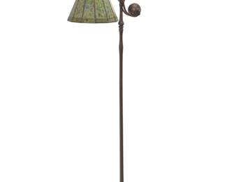 1130 A Tiffany Studios floor lamp Early 20th century Base impressed to underside: TIFFANY STUDIOS / NEW YORK / 681 The patinated bronze base model 681, with swiveling counter-balance issuing a swiveling, possibly Tiffany Studios twelve-panel dichroic glass shade, electrified 54.75" H x 17" W x 11.5" D Estimate: $6,000 - $9,000