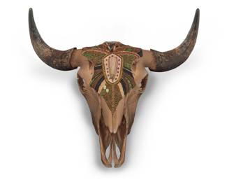 1114 Suzanne Schmaltz (b. 20th century, American) A beaded American bison skull, early 21st century Unsigned The gold-toned skull mounted with glass and metal beads, hardstone accents, and hammered copper 24" H x 28" W x 9" D Estimate: $800 - $1,200