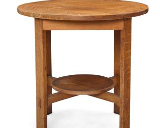 1129 A Stickley Brothers oak lamp table, no. 2508 Early 20th century Unmarked With circular undertier centering an X-stretcher 30" H x 30.25" Dia. Estimate: $500 - $800